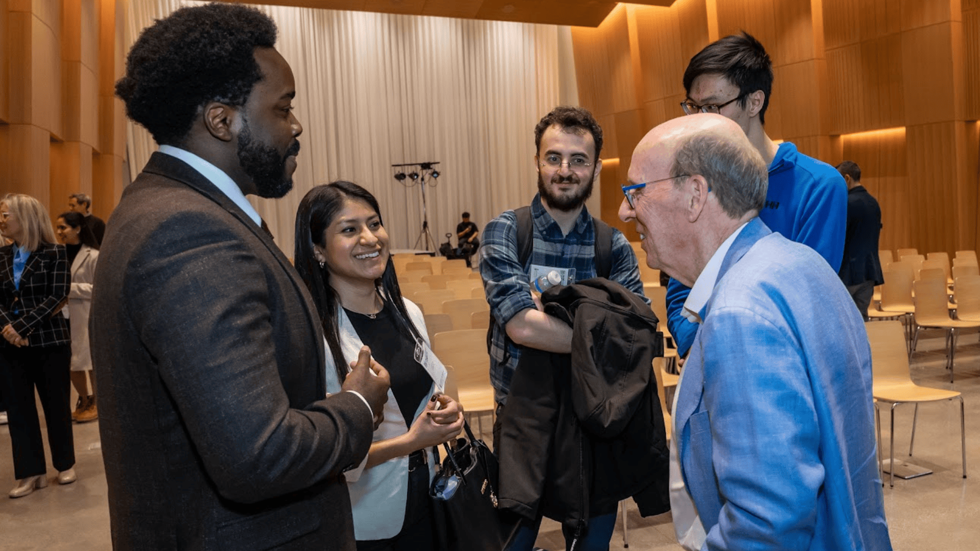Attendees networking with Stephen Smith