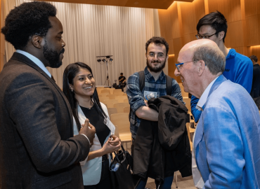 Attendees networking with Stephen Smith
