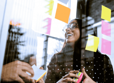 A student brainstorming an idea with colourful sticky notes