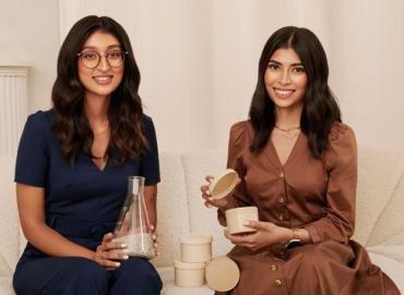 Tyagi and Siddiqui smiling while displaying plant-based products